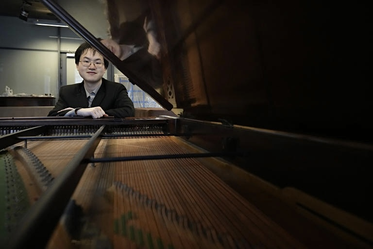 Eric Guo sits at Chopin's Piano