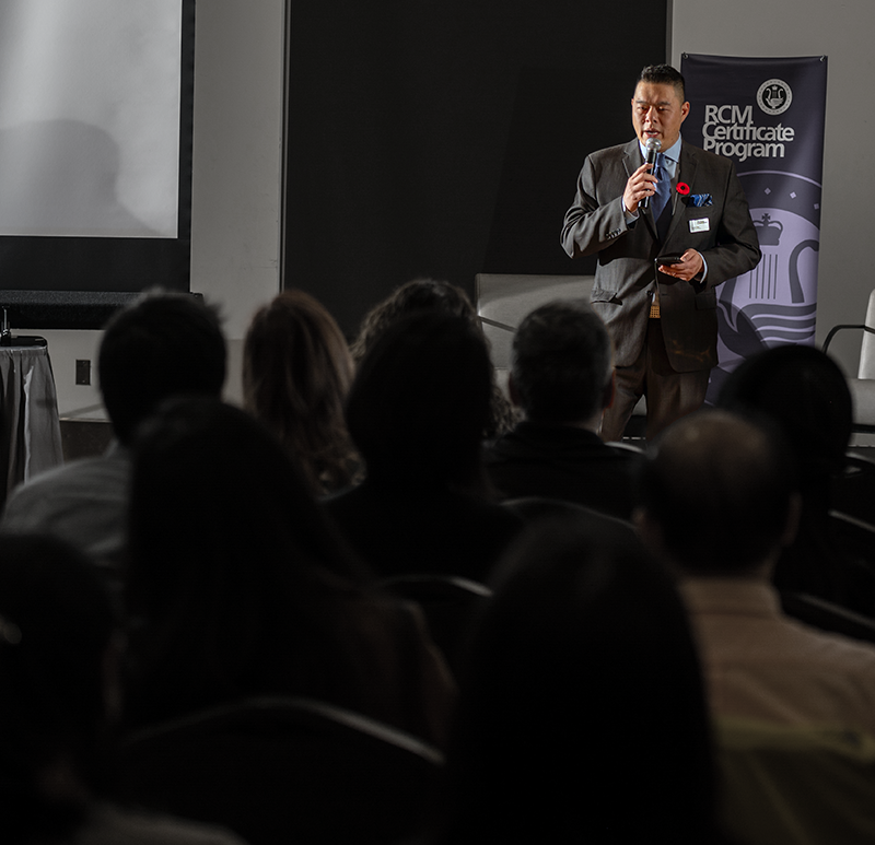 Man speaking in front of crowd